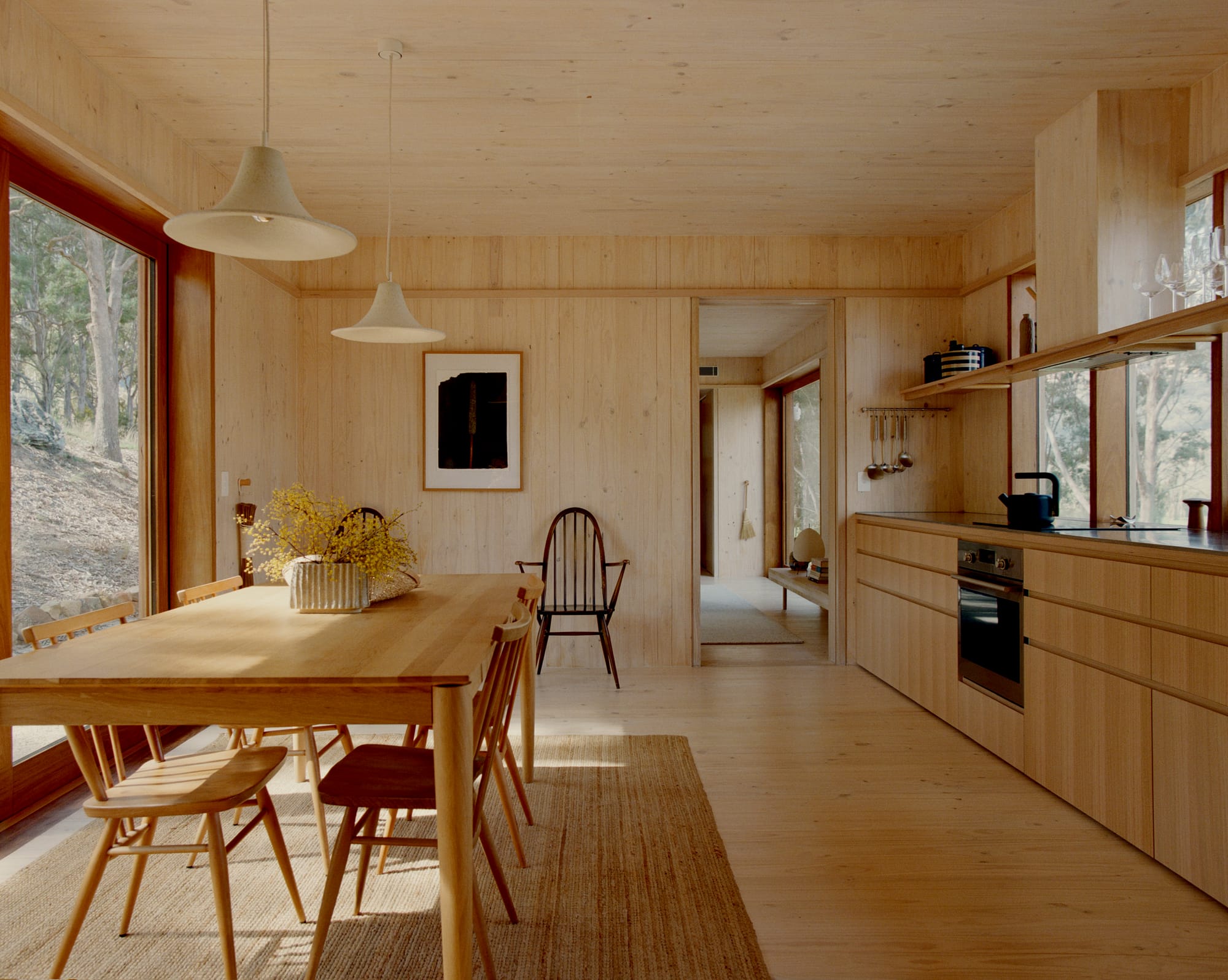 Practice Ground. Photography by Saskia Wilson. Open plan dining and kitchen space with light timber floors, walls, ceilings, joinery and furniture. 