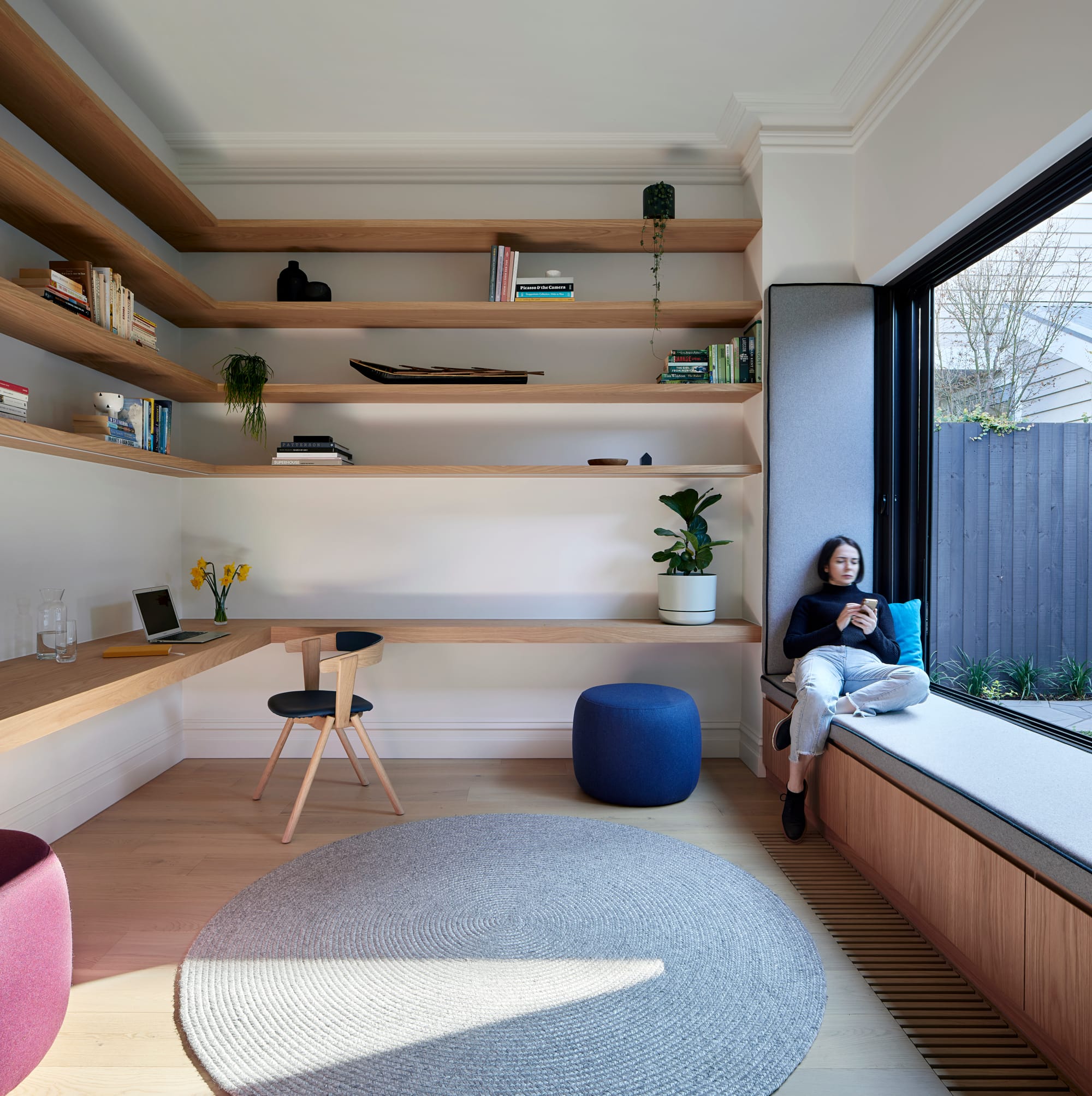 HMAS L02 by Rachcoff Vella Architecture. Photography by Tatjana Plitt. Residential office space with floating timber shelves, floors and integrated window bench seat. 