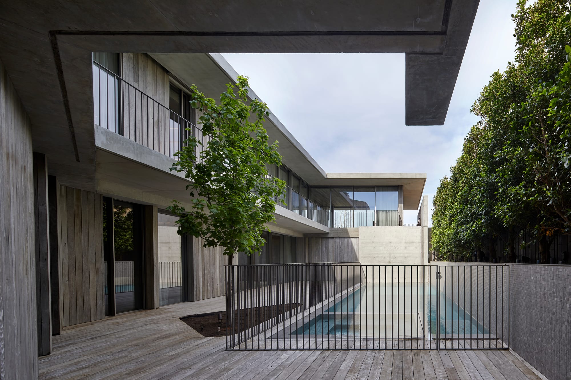 Silver Linings by Rachcoff Vella Architecture. Photography by Tatjana Plitt. Outdoor timber clad patio and residential building with balcony and pool. 