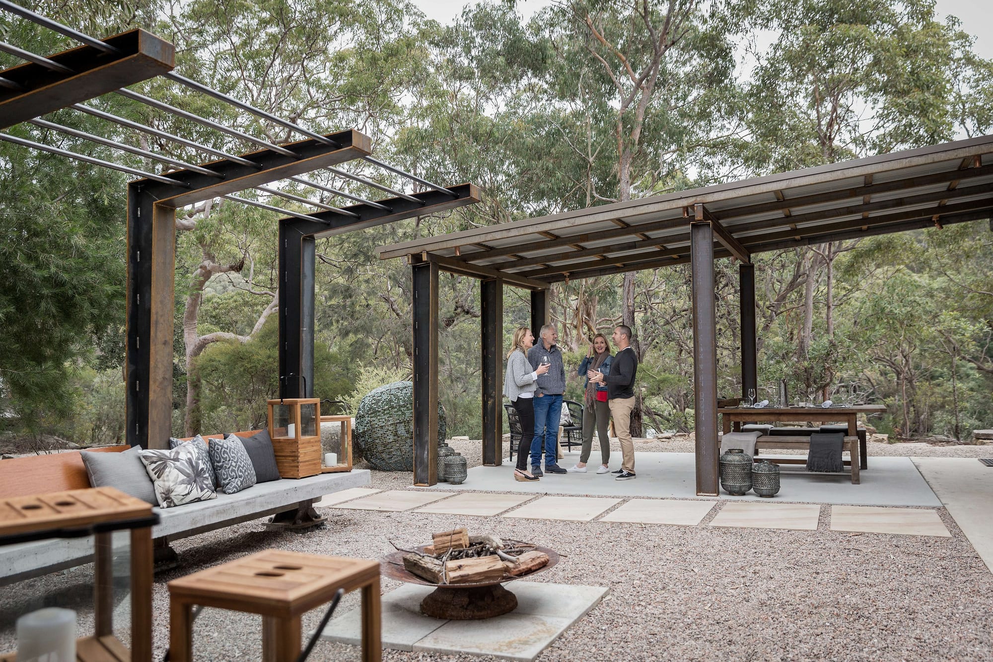 Spicers Sangoma by Barbara Tarnawski Architects. Outdoor entertaining area with firepit, gravel floors and slanted steel shade canopies.