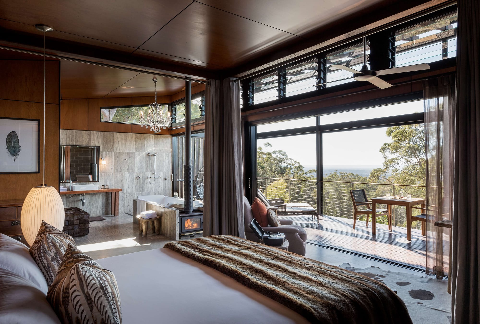 Spicers Sangoma by Barbara Tarnawski Architects. Bedroom opening onto raised exterior timber deck and open plan bathroom.