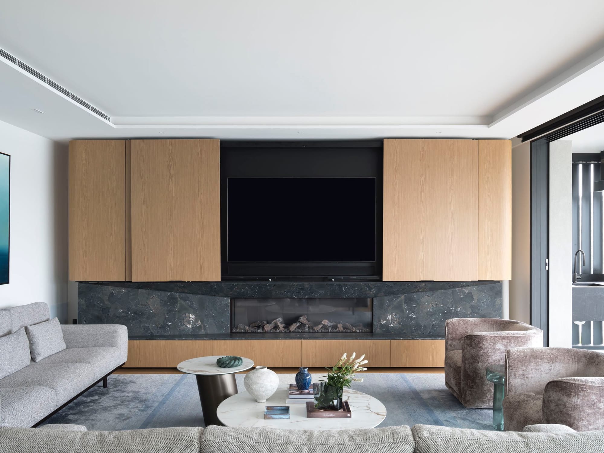 An interior shot of the living room showing the timber joinery and marble fireplace.