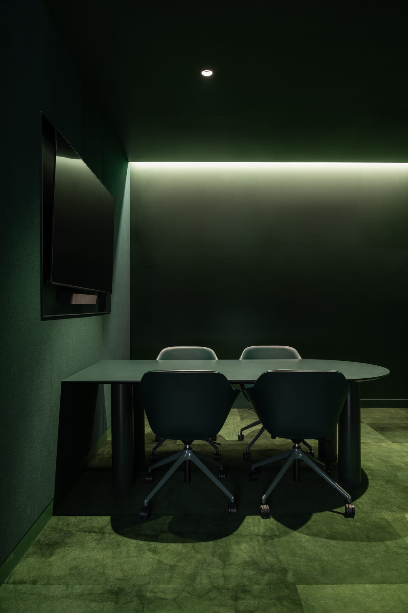 Hunt Architects Perth Studio. Photography by Dion Robeson. Meeting room with green carpet, walls, furniture and ceiling. 