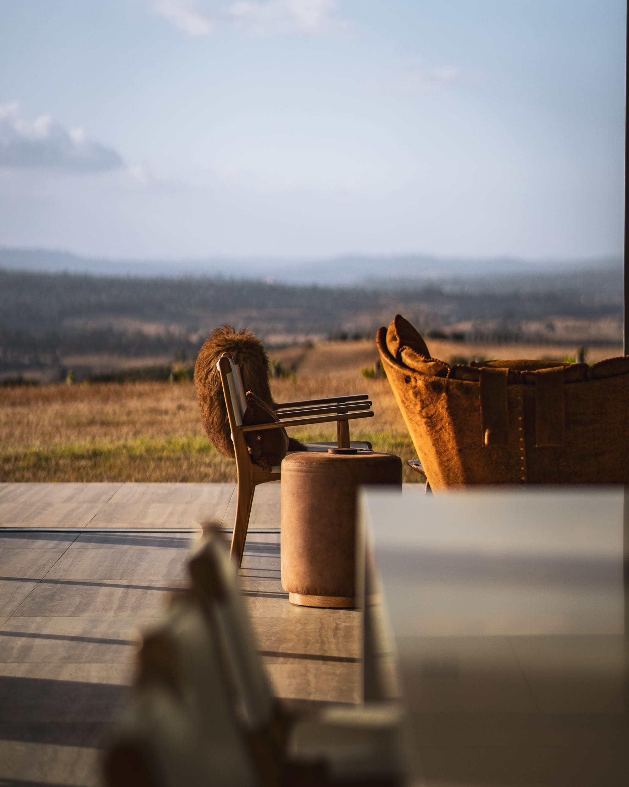 The Cloud at Sen Vineyard. Photography by Ben Little. Timber and leather chairs arranged on tile flooring in open space overlooking paddocks. 