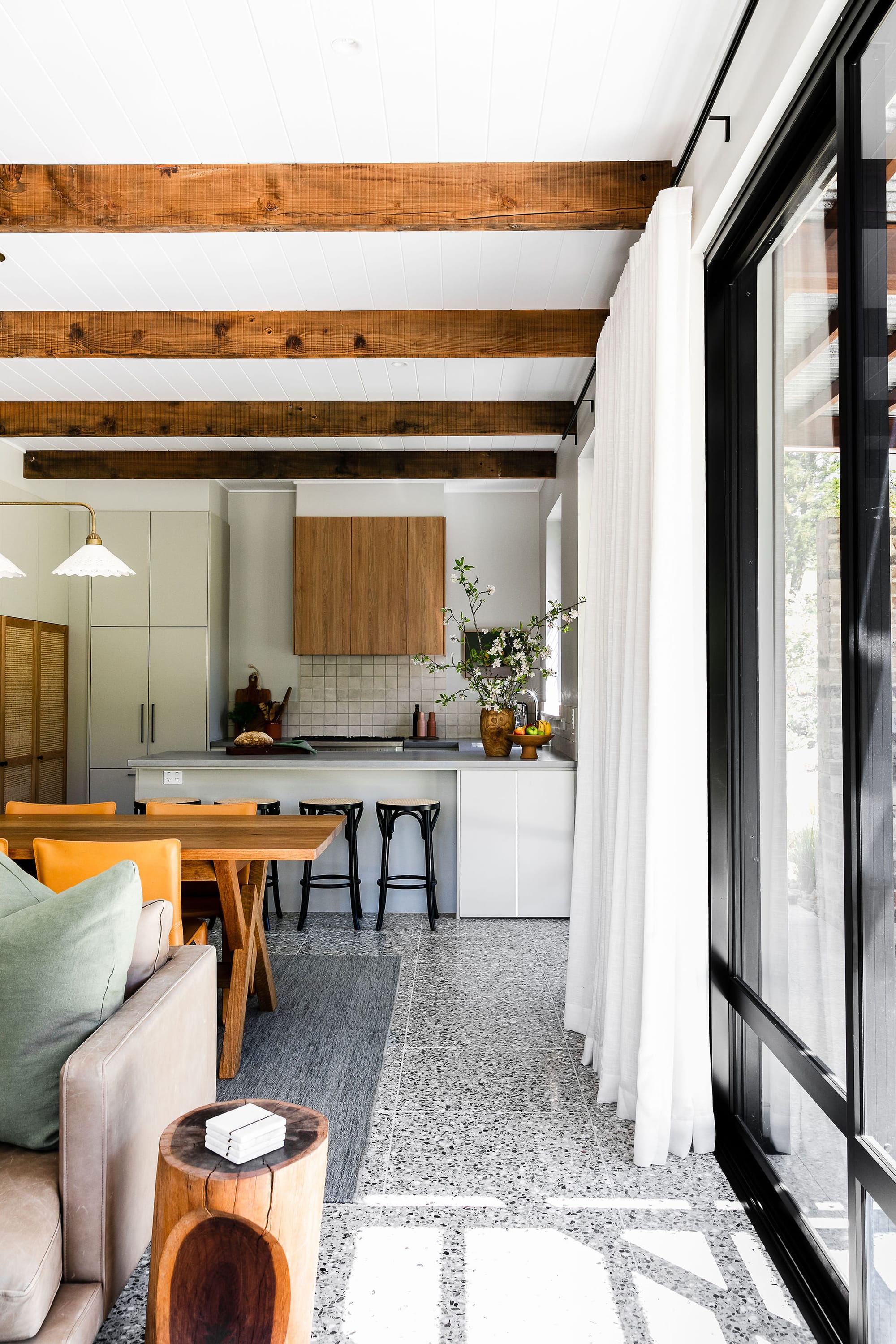 An interior shot of the main house at Hide and Seek Kangaroo Valley showing the kitchen, dining and living spaces.