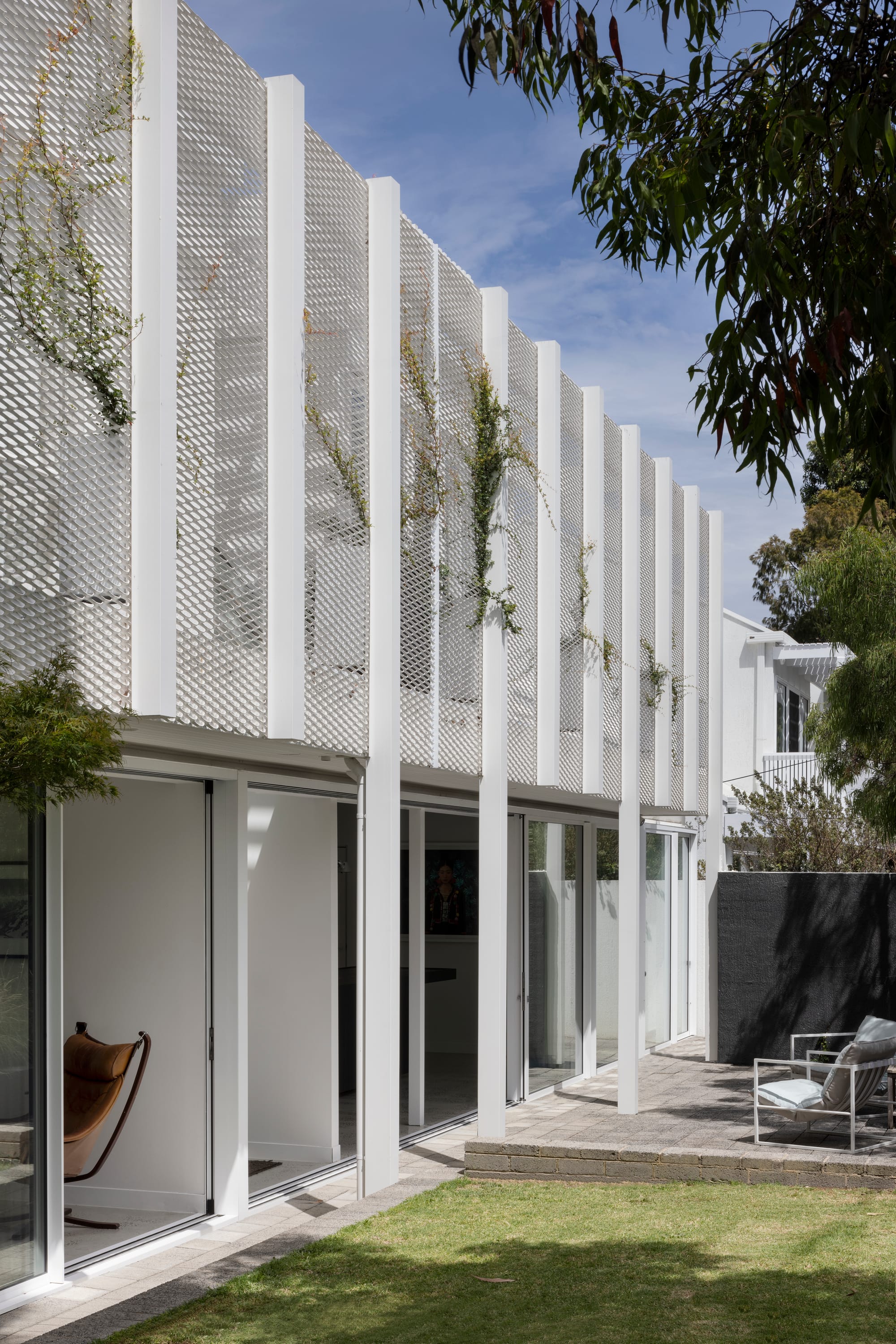 Beaumaris by Rachcoff Vella Architecture showing the exterior white metal screen and backyard courtyard.