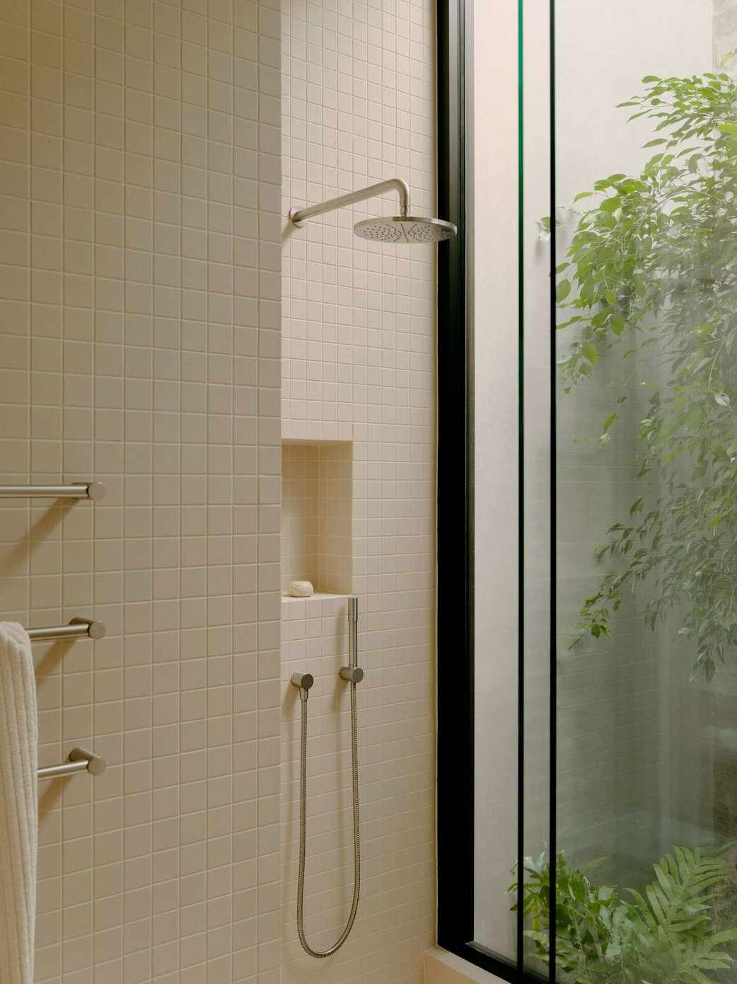 Fitzroy North House by Cera Stribley. Unknown photographer. Shower with beige tiles, shower recess and full height window looking onto courtyard garden.