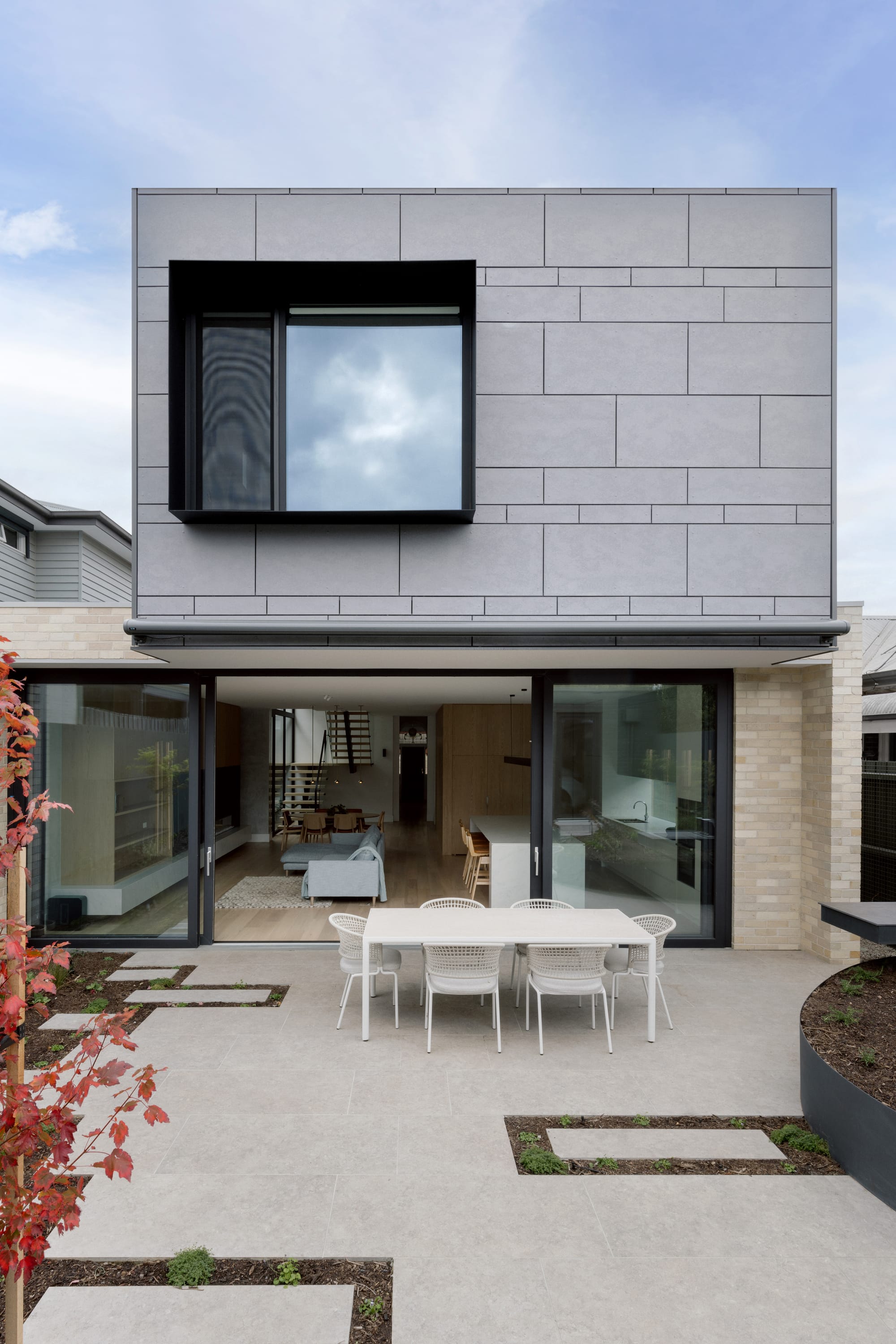 Auburn Residence by Chan Architecture. Photography by Elise Scott. Rear facade of double storey contemporary home with brick finish on lower floor and cement on second floor.
