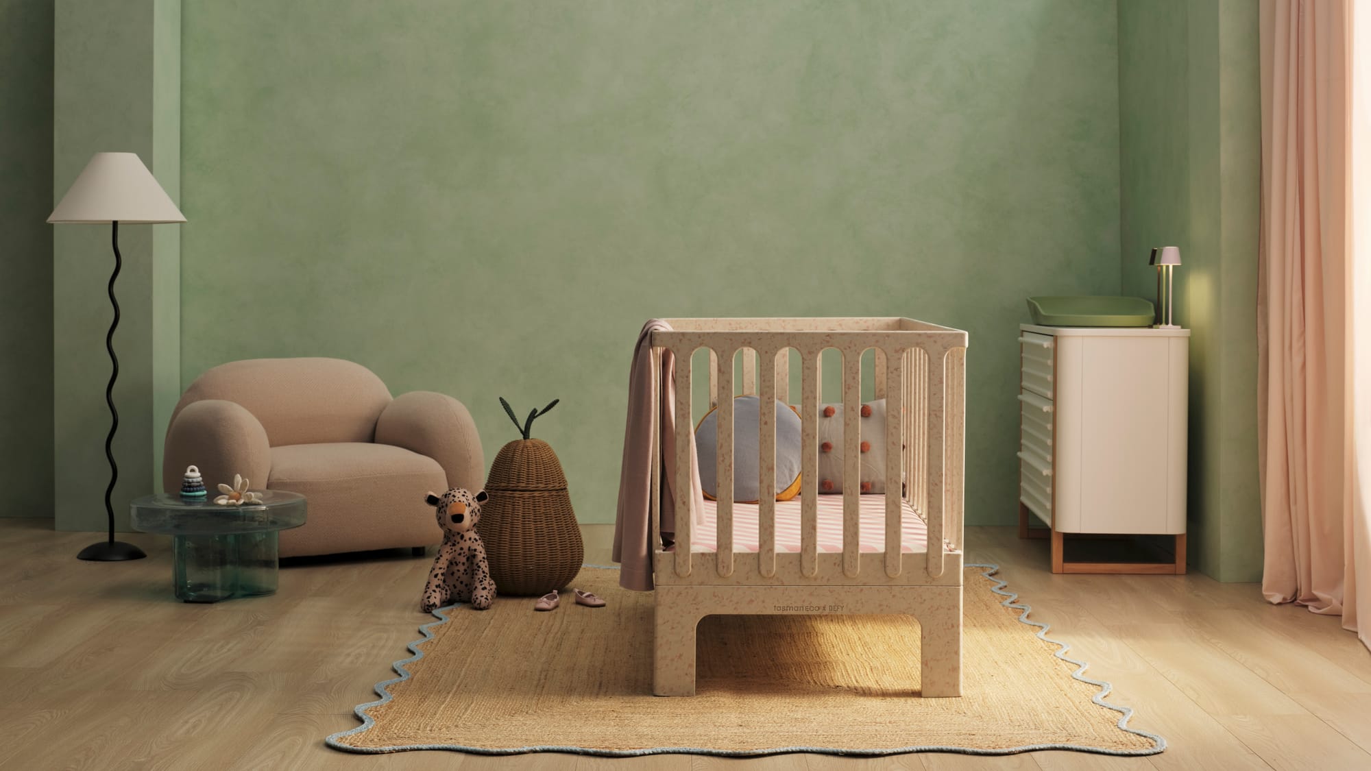Archie Cot by Seena x Defy in Dalmation Pink. White cot in room with green walls, timber floors and jute rug.