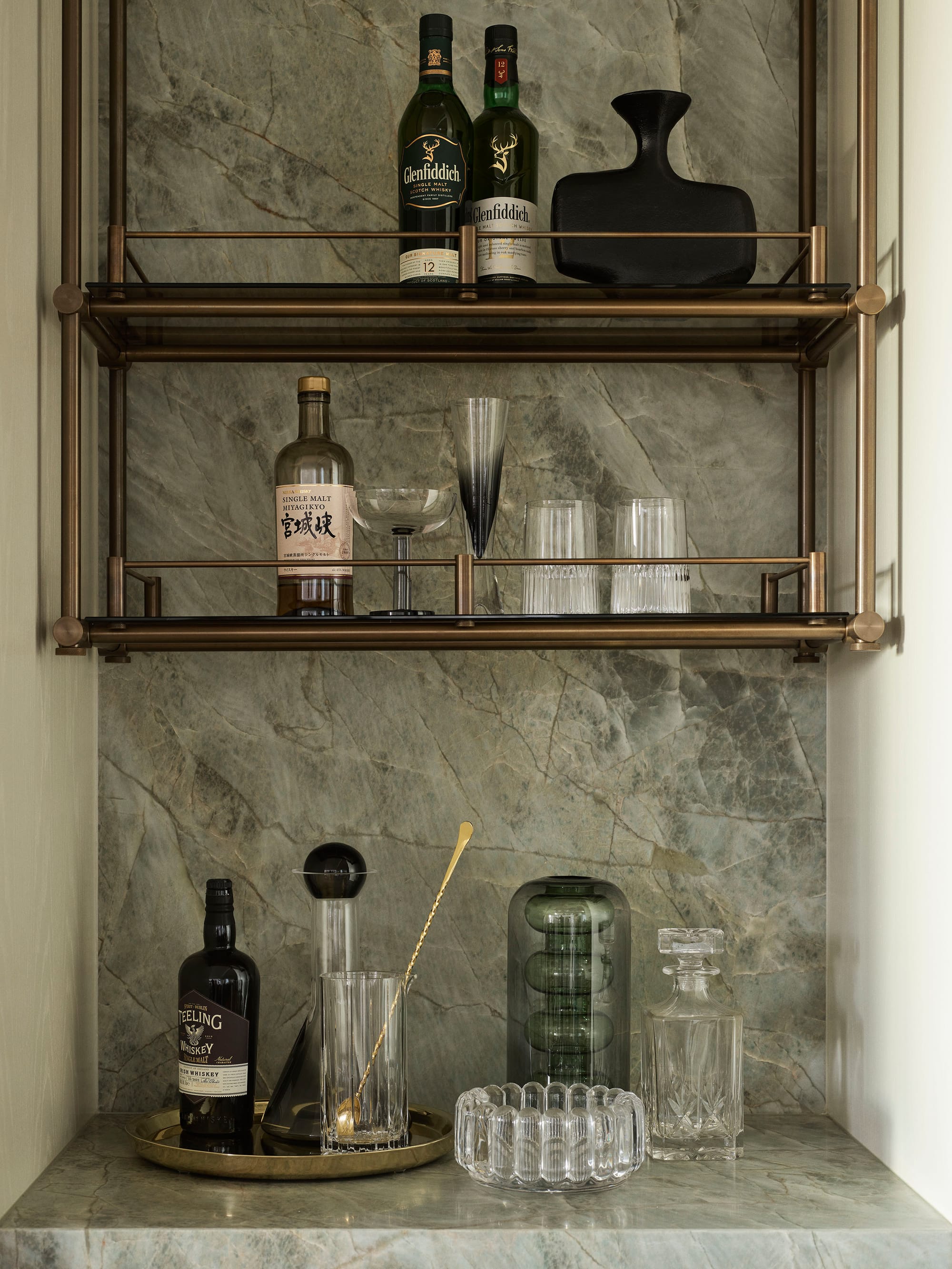 Bundarra Penthouse by Marylou Sobel Interior Design. Photography by Anson Smart. Integrated bar with jade green marble countertop and splashback, and copper overhead storage.