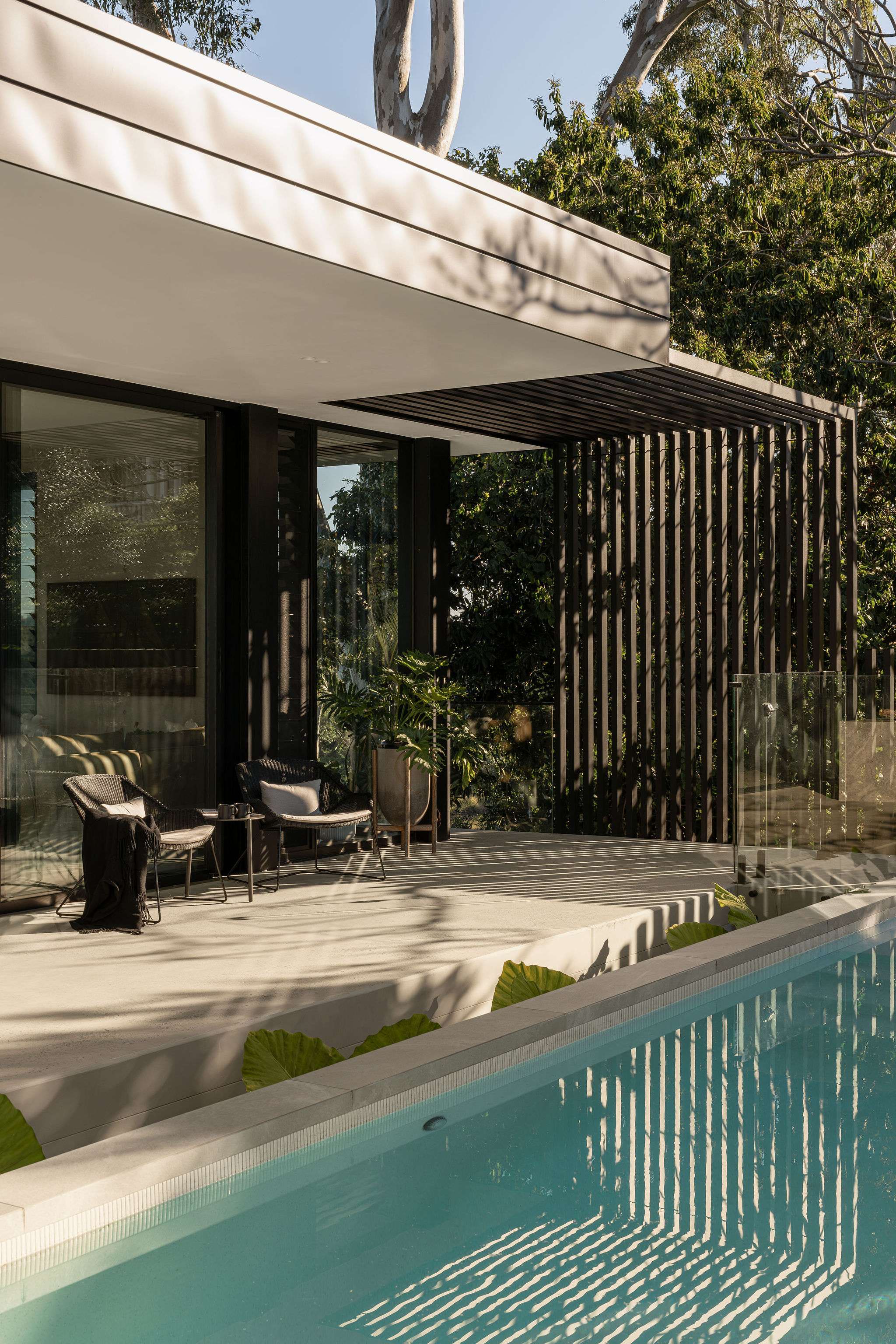 The River House, Indooroopilly by Sarah Waller Architecture. Photography by Alyne Media. Balcony with concrete flooring overlooking river below.