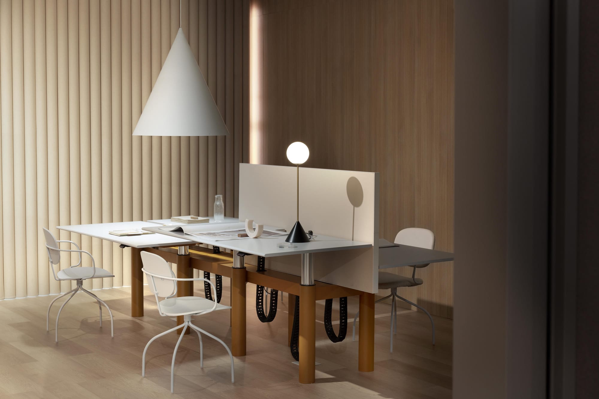 IOC Project Partners, Brand Partner for M&E Interiors. Work desk formation with timber legs, white chairs and white dividing screen.
