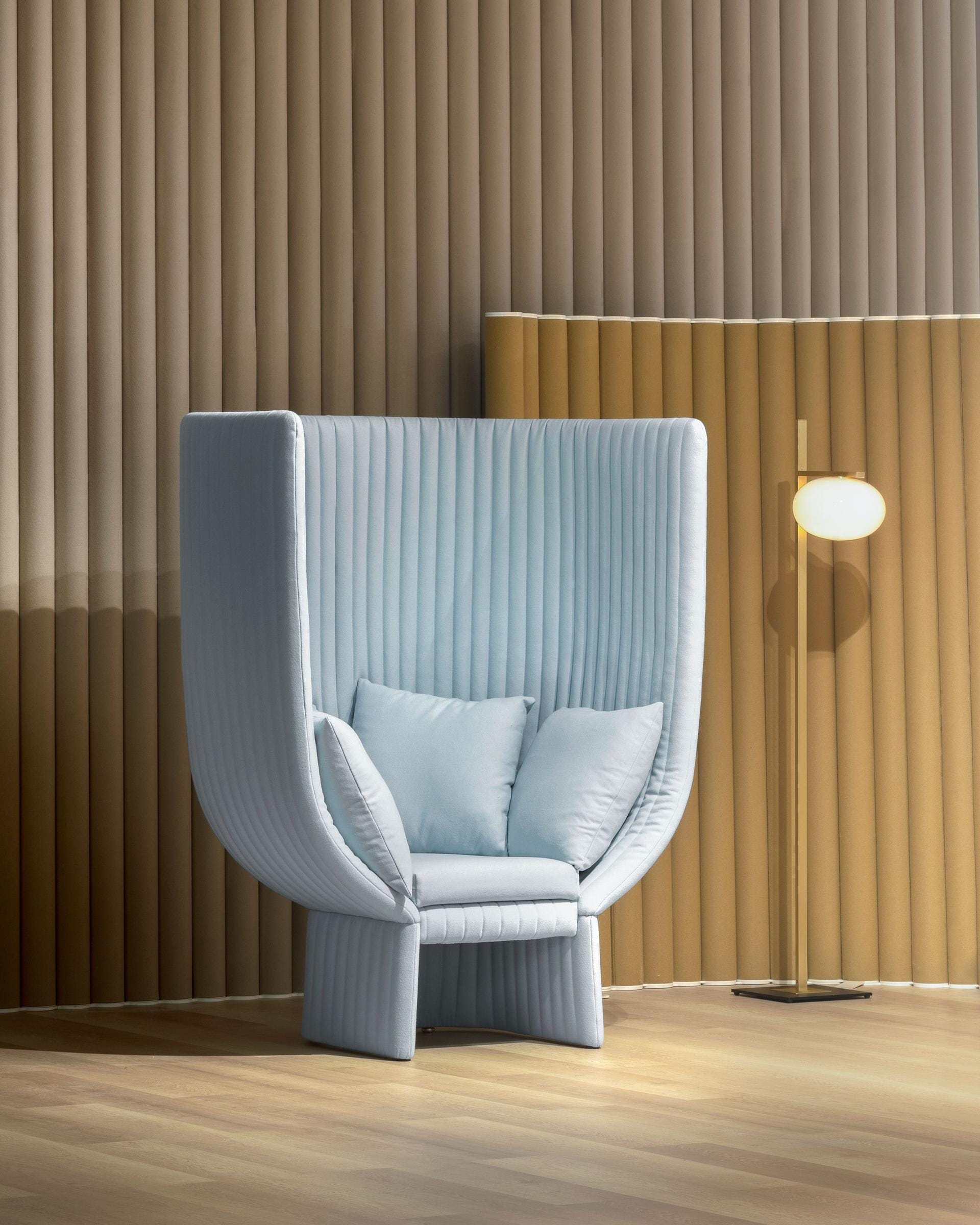 IOC Project Partners, Brand Partner for M&E Interiors. Abstract powder blue tufted armchair with cushions.