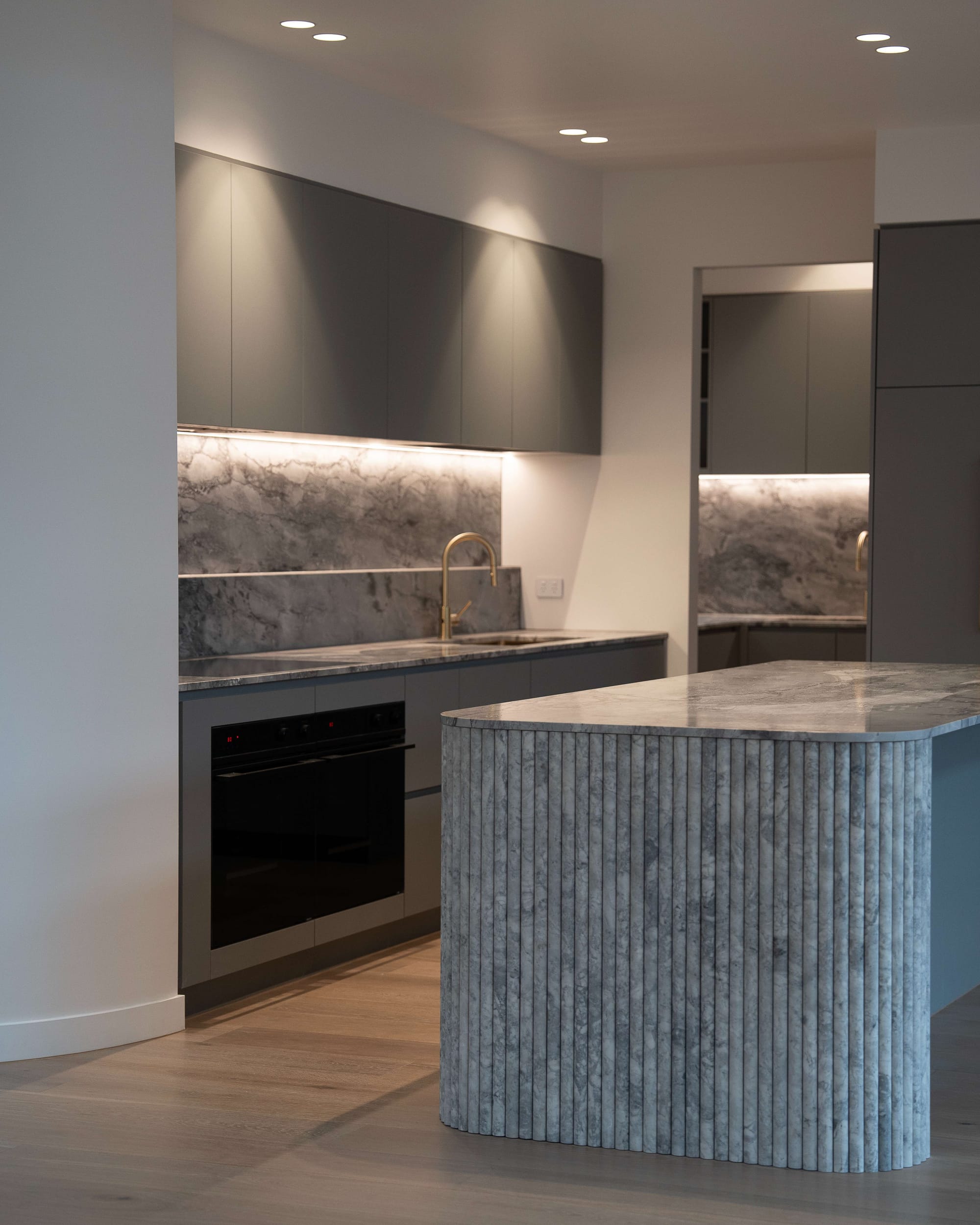 Murrumbeena by PREM.BUILT. Image copyright of Prem.Built. Kitchen with stone splashback, countertops and fluted island bench kickboard. 