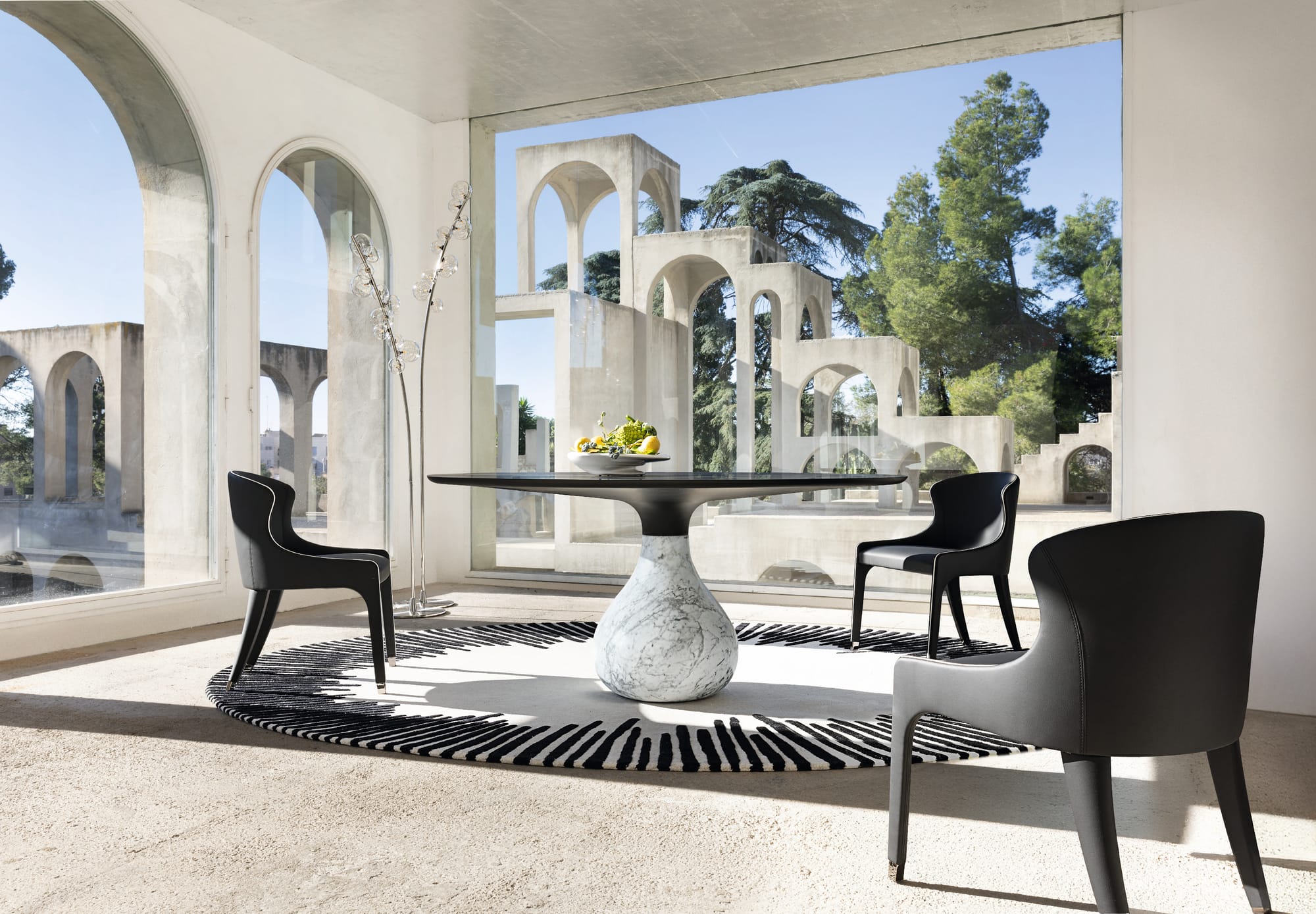 Aqua table by Roche Bobois. Image copyright of Roche Bobois. Black and white themes lounge with striped mat.