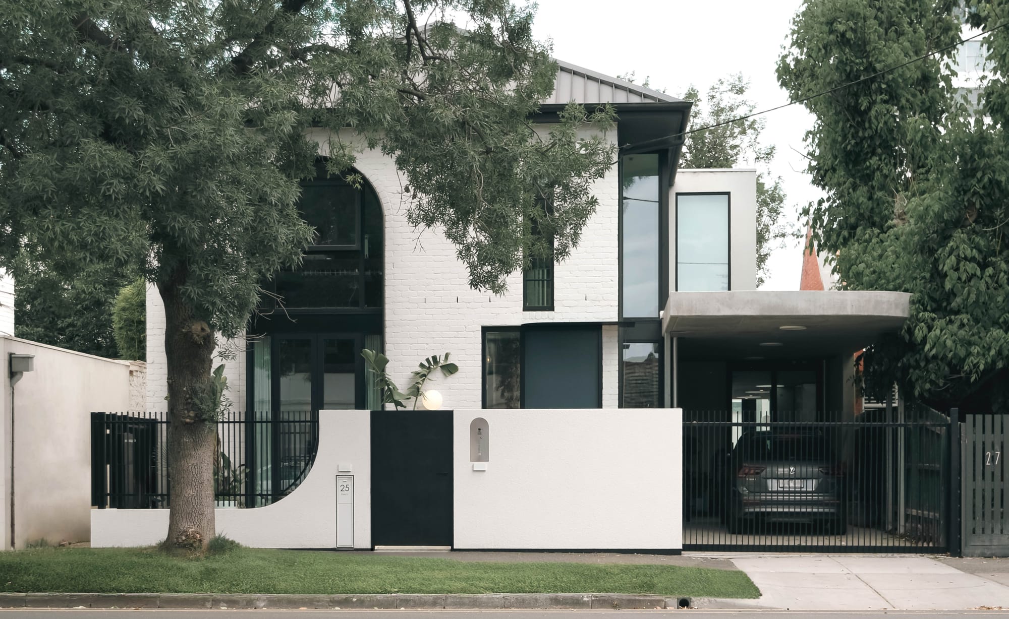 Park St by SGKS ARCH. Photography by Tania Lee. Hallway with concrete floors, peach walls and metal staircase.