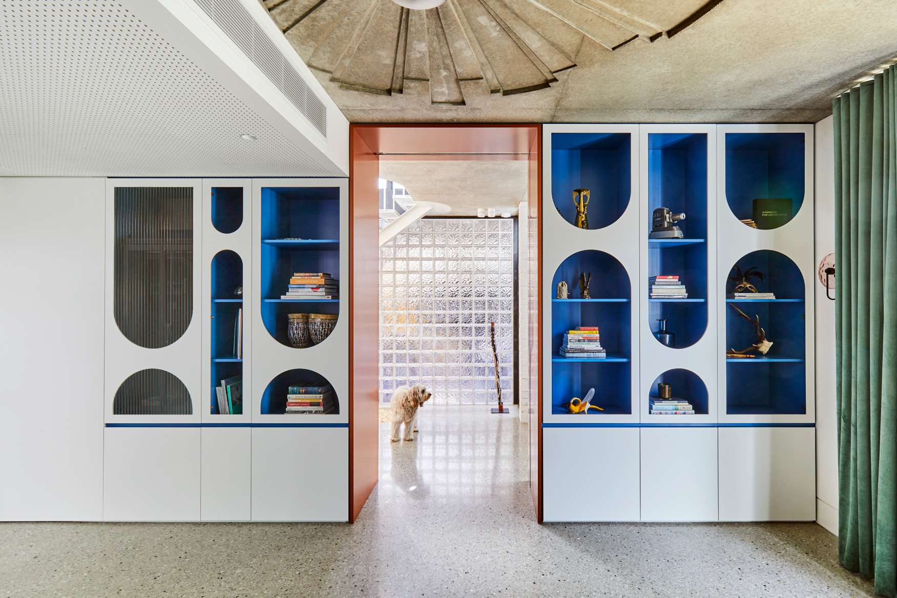 Park St by SGKS ARCH. Photography by Tania Lee. Abstract storage units on walls with arched, blue cut outs on white cabinetry.