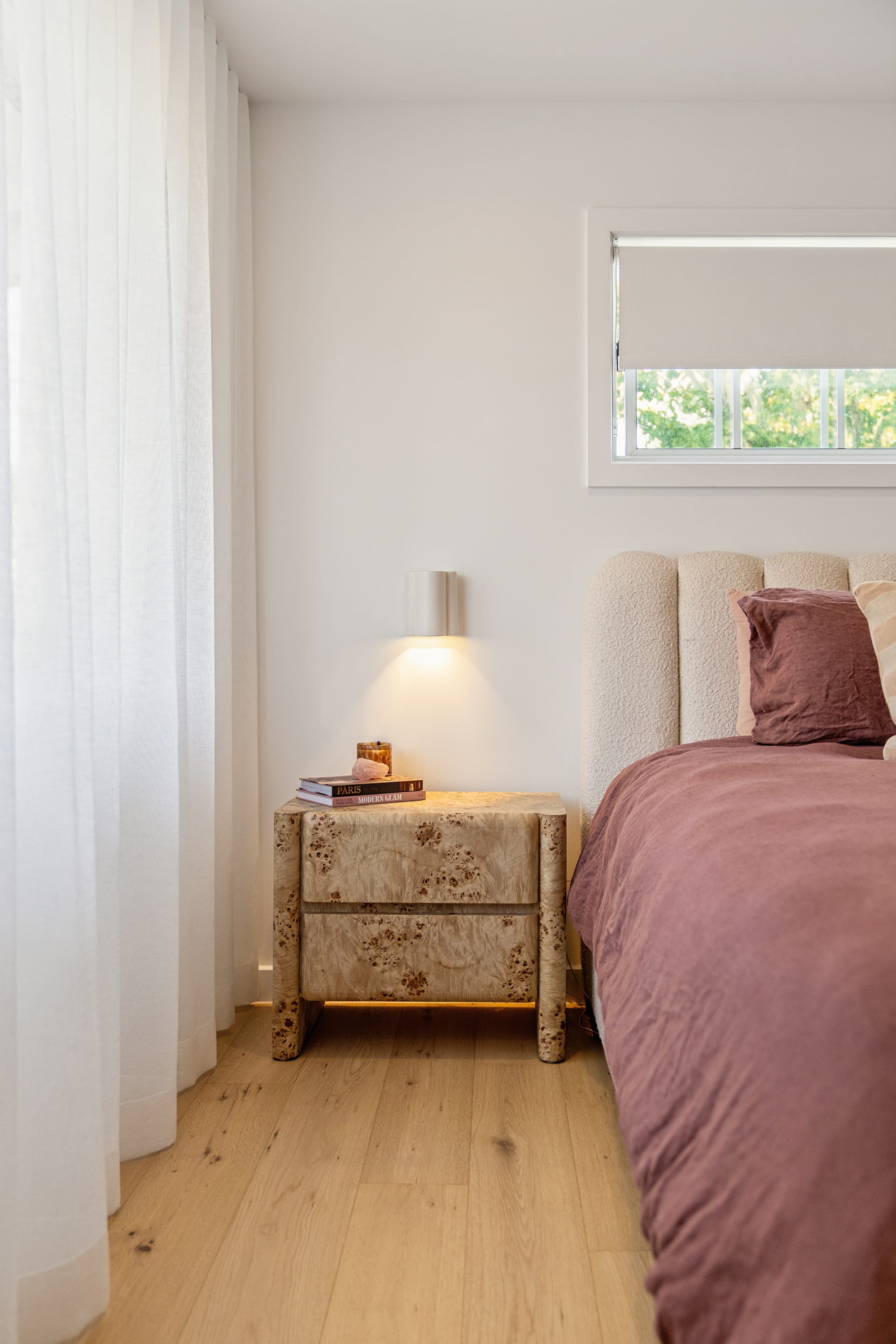 Chardonnay Court House by Studio MDM. Photography by Focl Media. Bedroom with plum linen bedding, light timber floors and timber grain bedside table. 