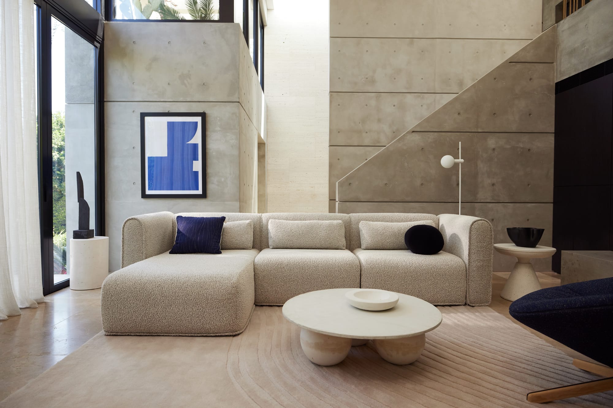 Koala's Bangalow Modular Sofa Bed in Limestone in a concrete house.