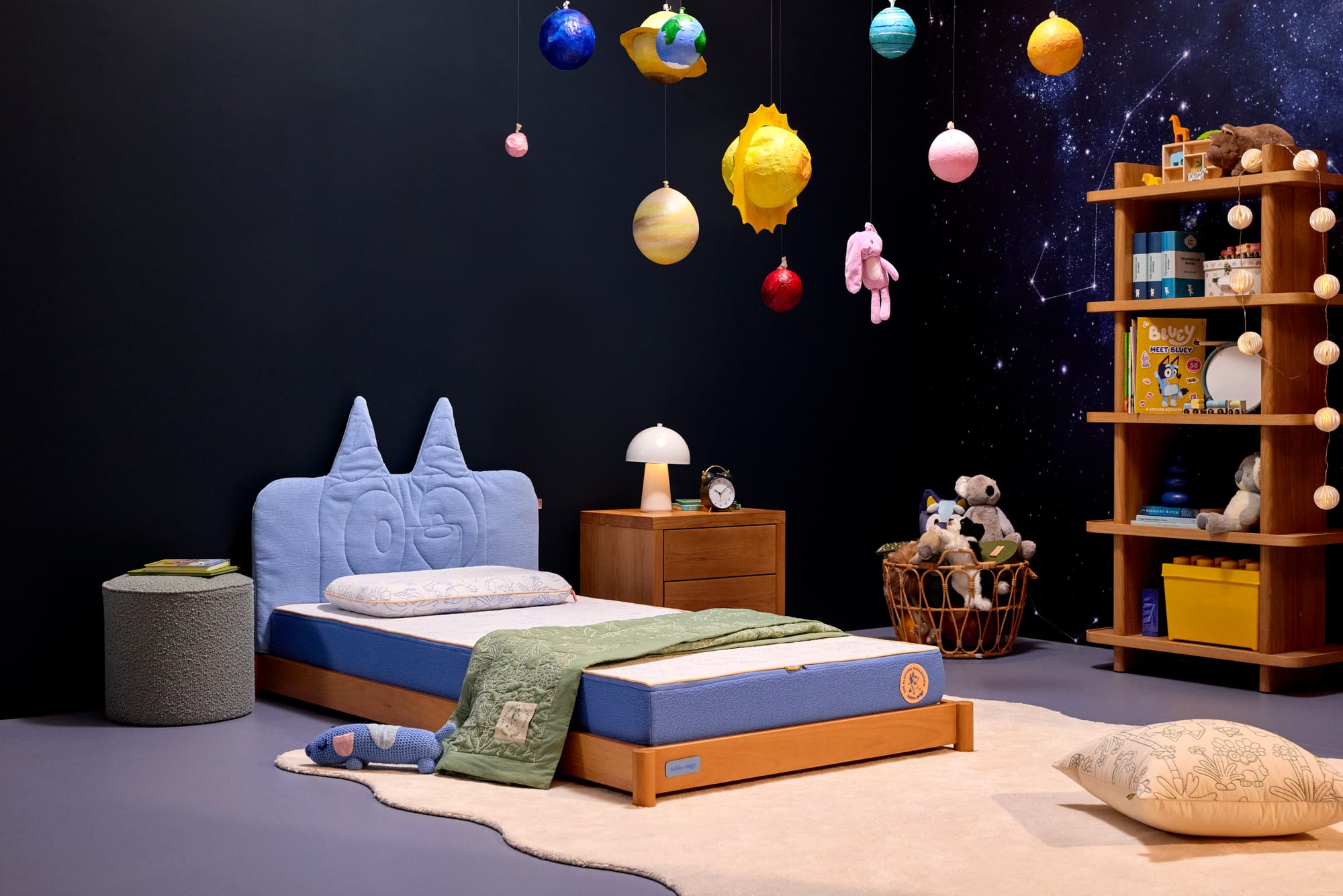 Koala Bluey Collection. Childs bedroom with dark walls, a timber and blue bedframe and large white rug.