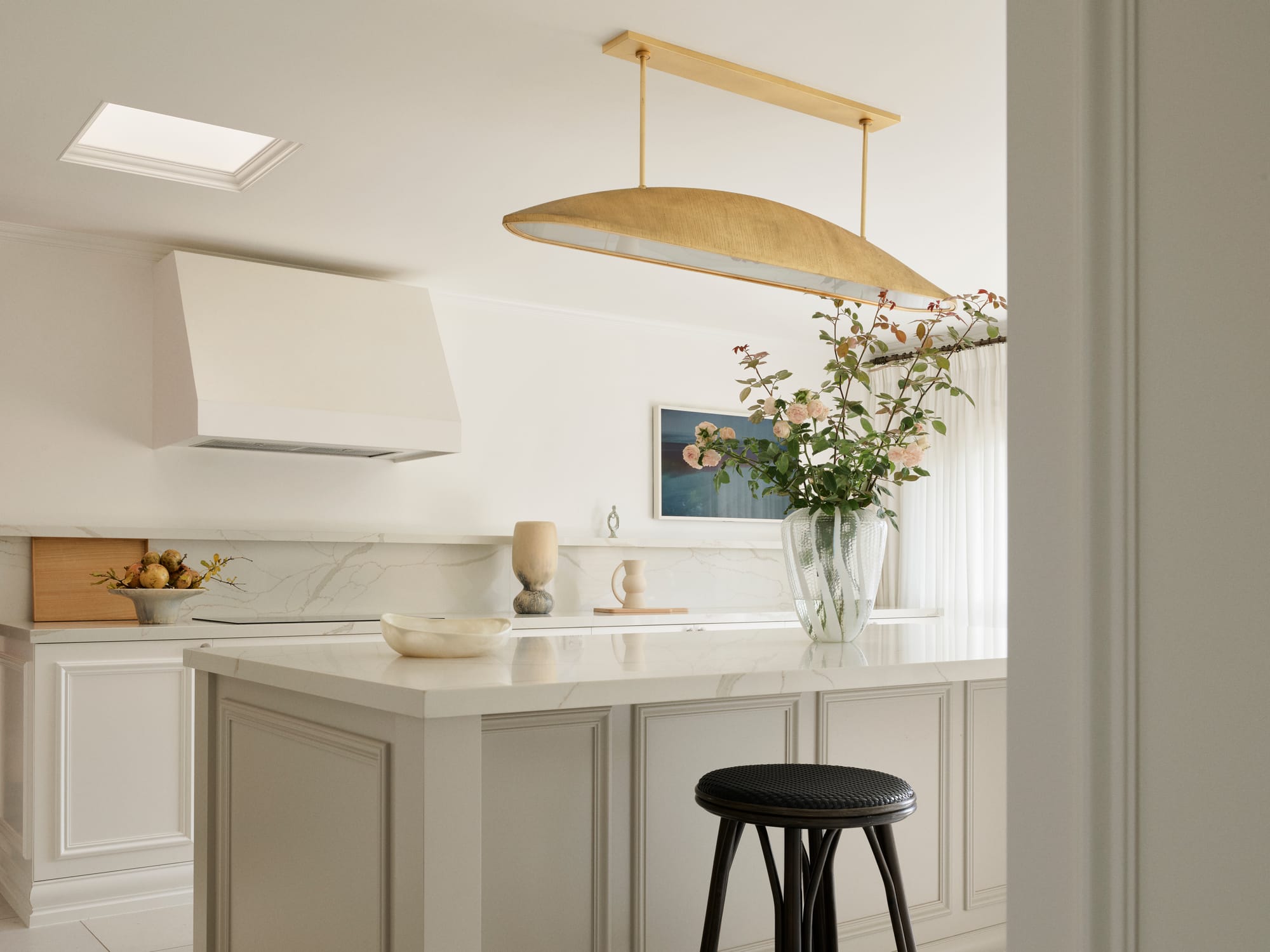 The Darling Edit by Marylou Sobel Interior Design. Photography by Anson Smart. Kitchen with white stone countertops, light grey cabinets, and white walls.