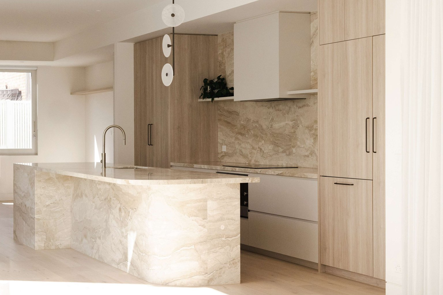Richmond Heritage Extension by Archive. Photography by Tessa Carroll. Kitchen with stone island bench, light timber cabinetry and white walls.