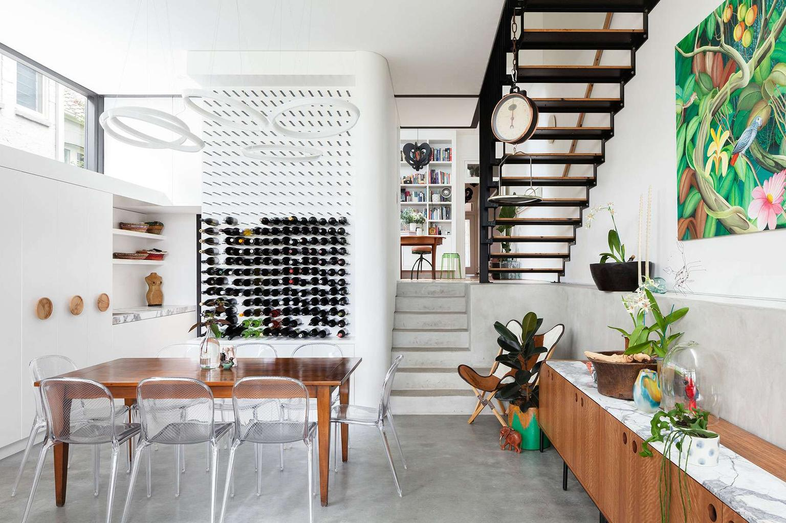 Randwick by Matt Day Architect. Photography by Katherine Lui. Sunken dining space with concrete floors, white walls, and wine rack wall.