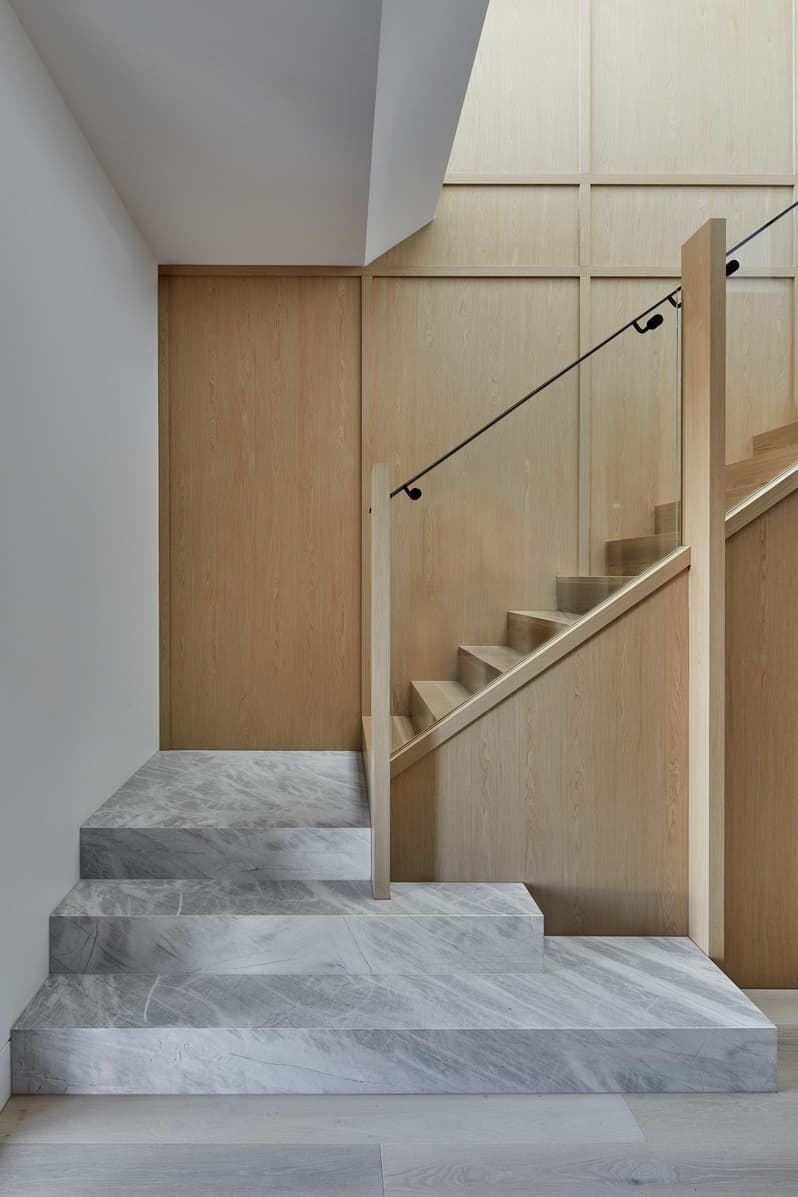 Horizon Home by Samuel Architecture. Photography by Dave Kulesza. White stone and light timber staircase leading upstairs. 