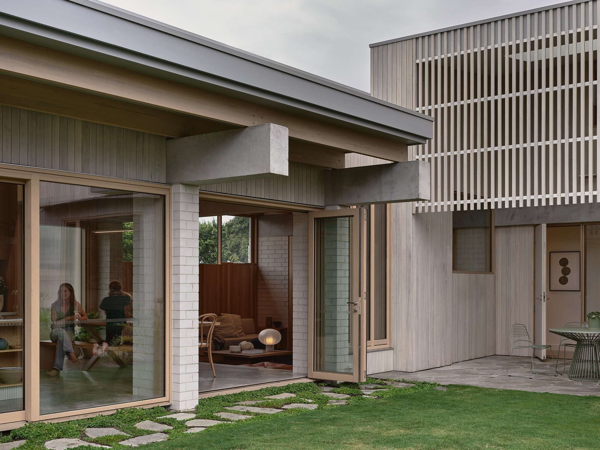 Home Pavilion by MRTN Architects. Brick, concrete and timber facade of home facing onto grassed courtyard. 