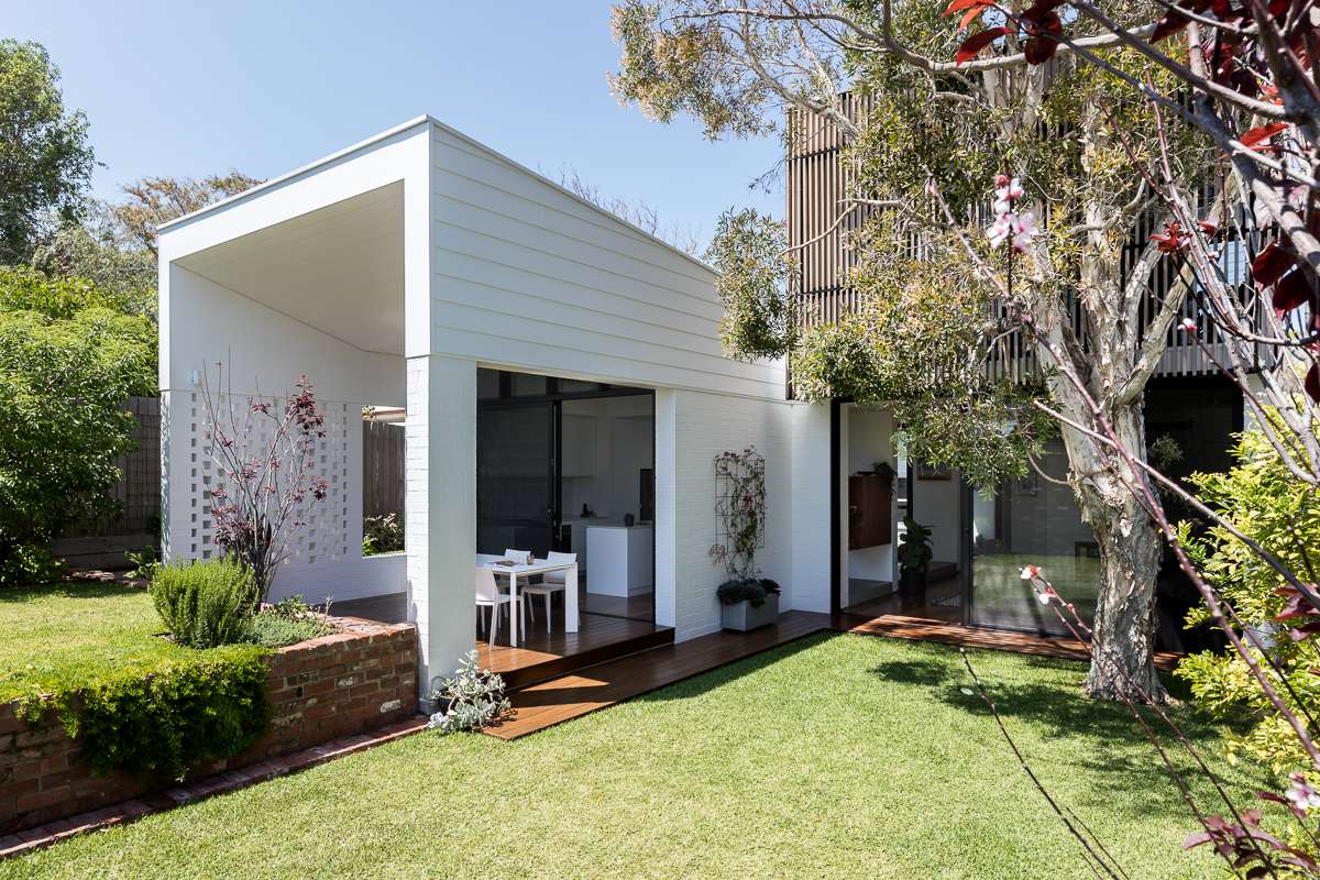 Modern home extension with indoor-outdoor flow, timber decking, and garden setting, highlighting a seamless Perth renovation