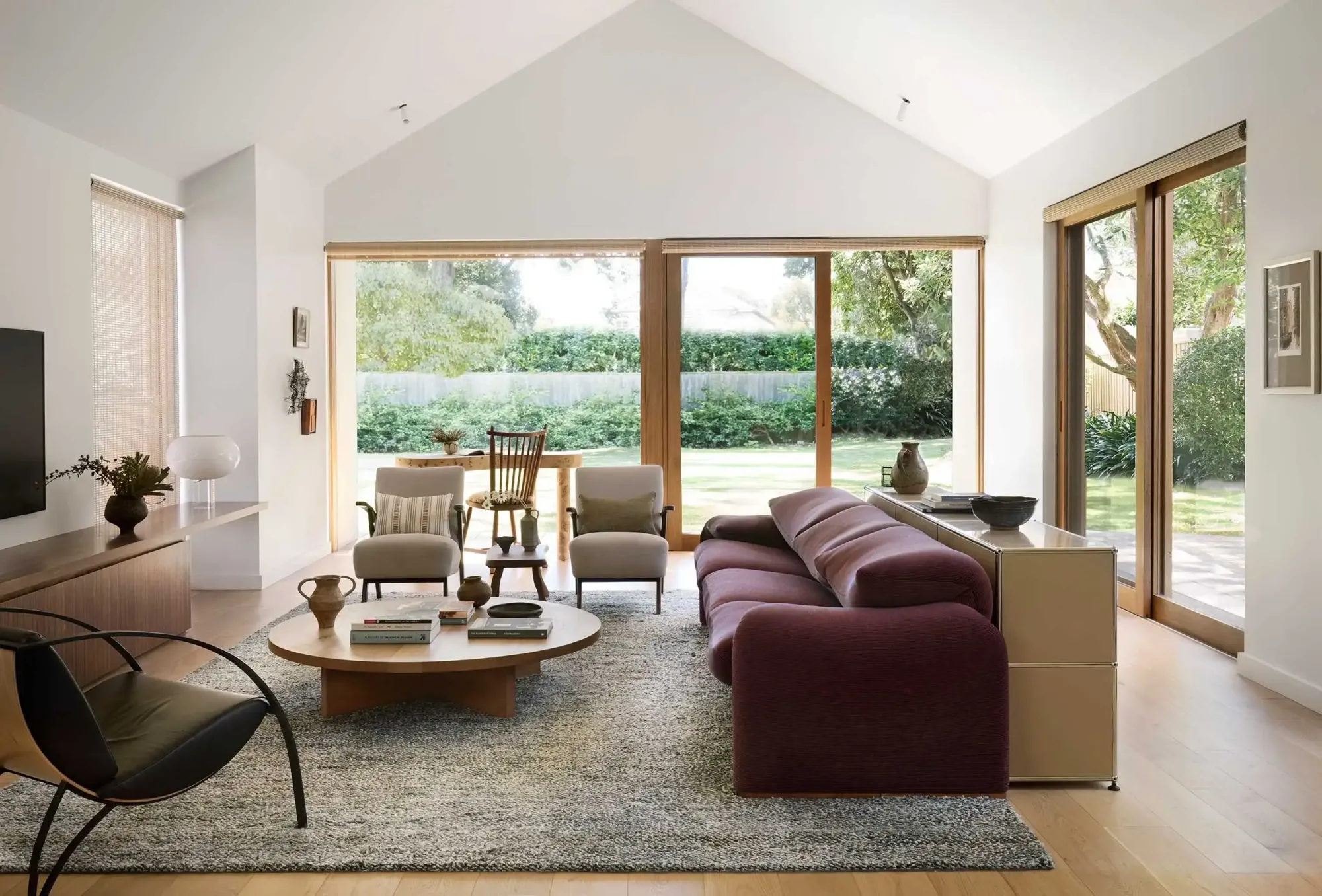 Light-filled living room with vaulted ceiling and garden views, highlighting contemporary home renovation in Sydney