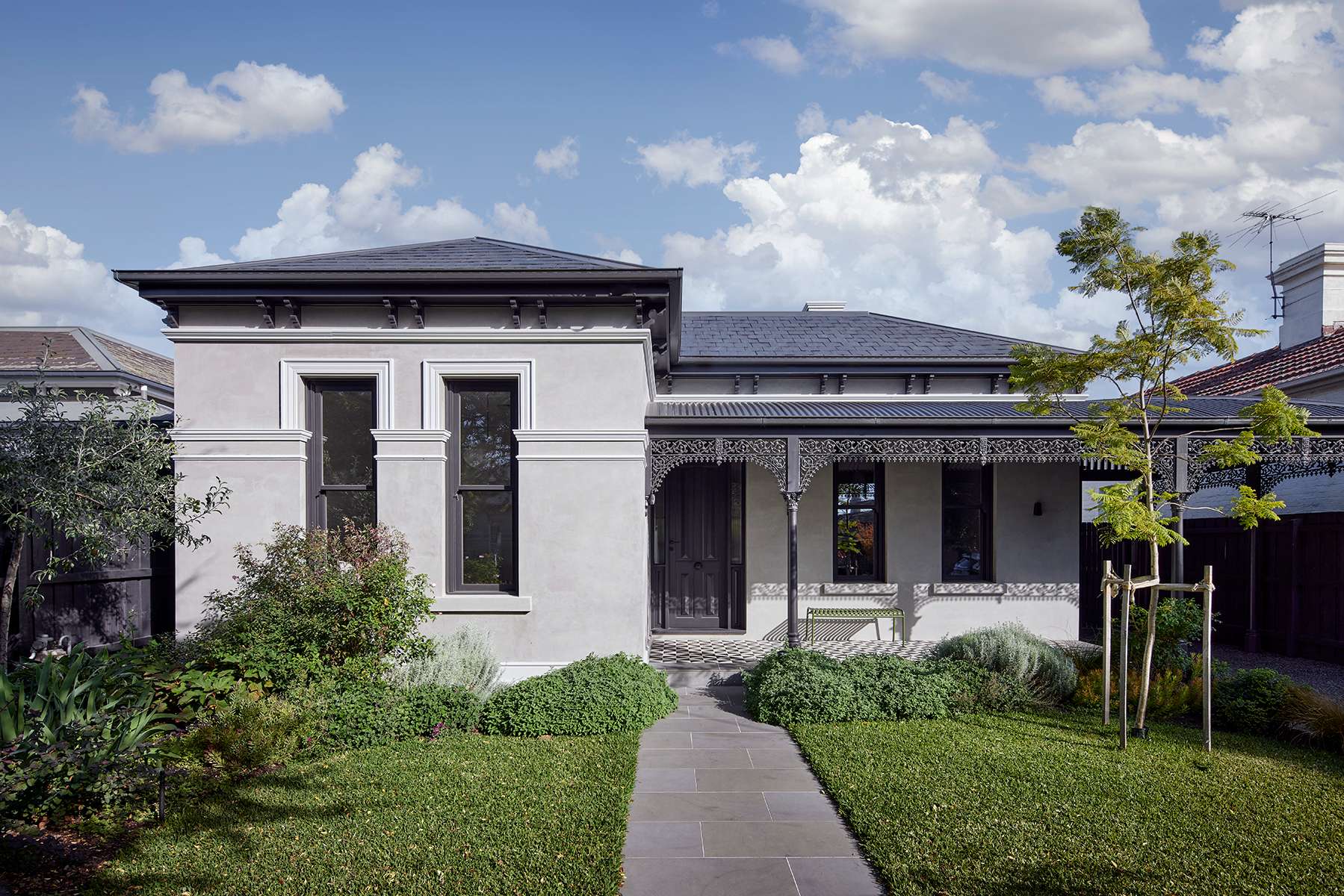 Restored heritage home facade with ornate veranda and landscaped front garden, showcasing a classic Perth renovation