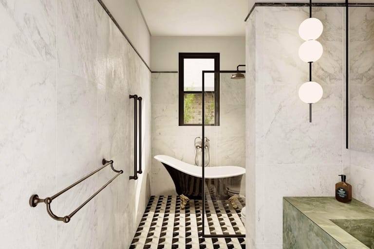 Elegant bathroom with freestanding bathtub, marble walls, and geometric flooring from a high-end renovation in Sydney