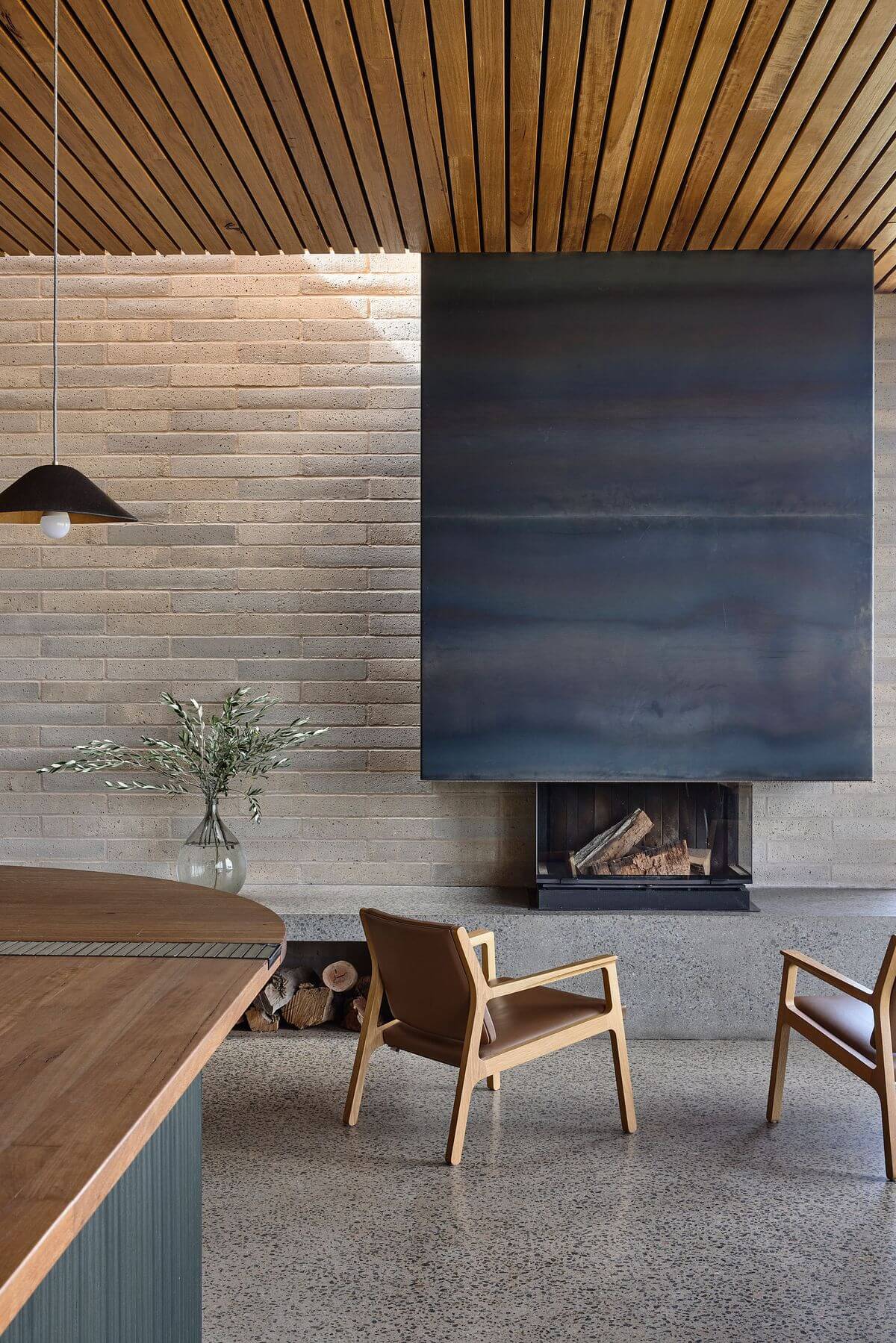 Delatite Cellar Door by Lucy Clemenger Architects. Feature view of seats facing fireplace. 