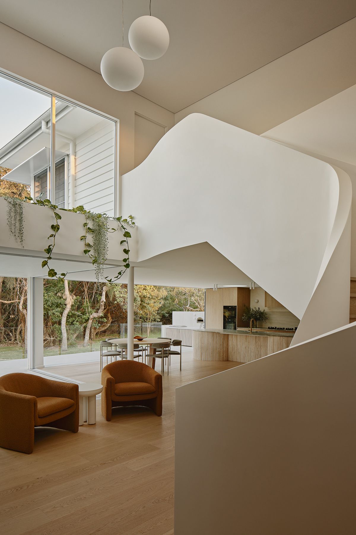 Oceanic House by OGE Group Architects and Kate Cooper Interiors. View into living, Kitchen dining area leading to outdo