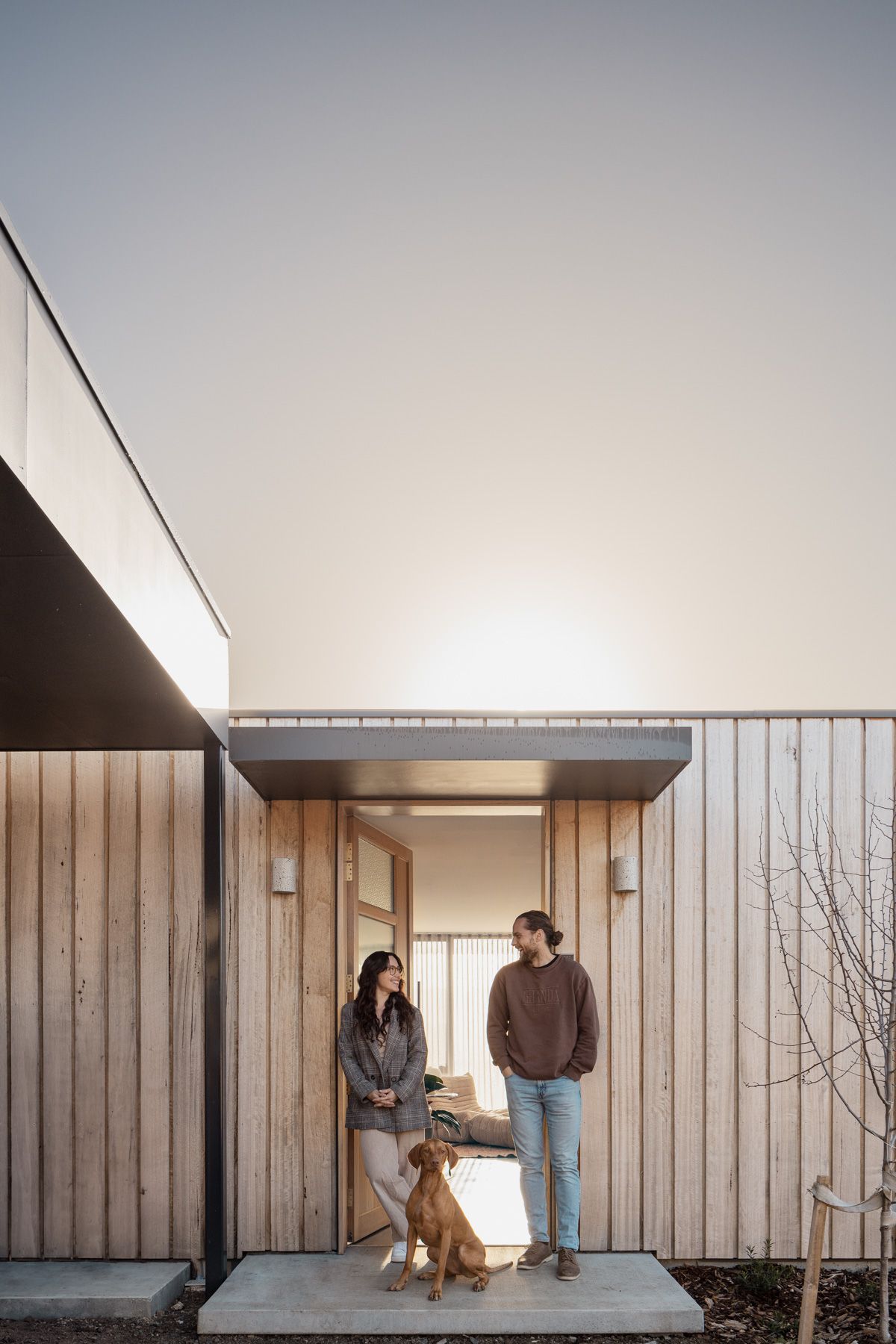 We Ponder House by Align Architecture with Saxon Hall Architecture showing owners at the front door with their dog