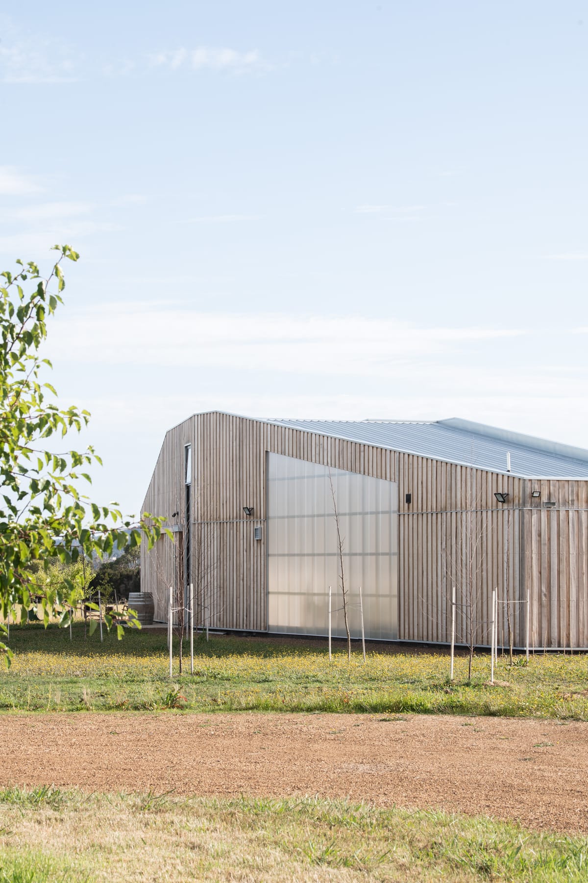 Exterior view of Westella Vineyard's building with a corrugated metal roof, blending modern and rustic design elements.