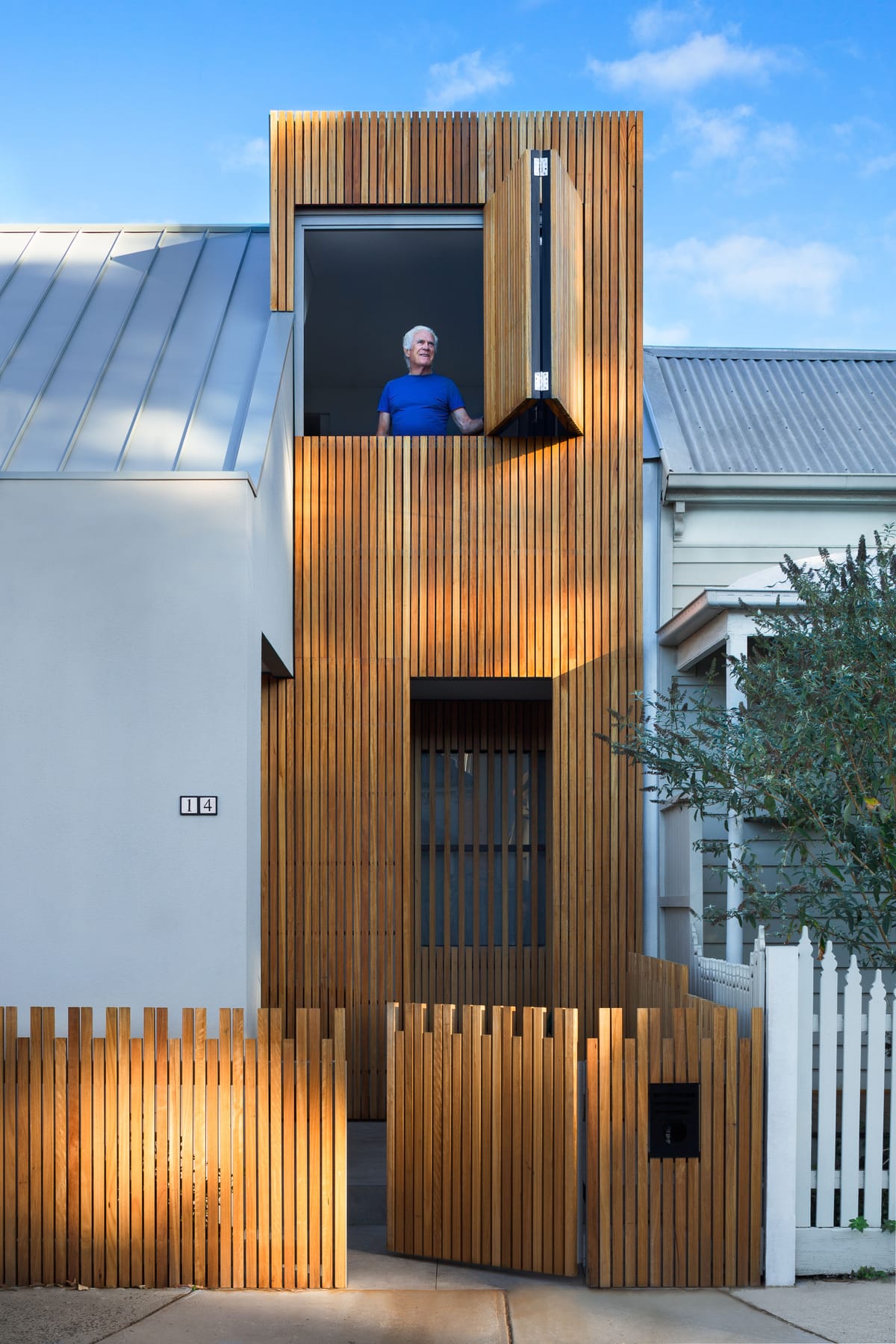 Cremorne House by Trethowan. Photography by Emily Bartlett. Double story timber clad residential home with window on top floo