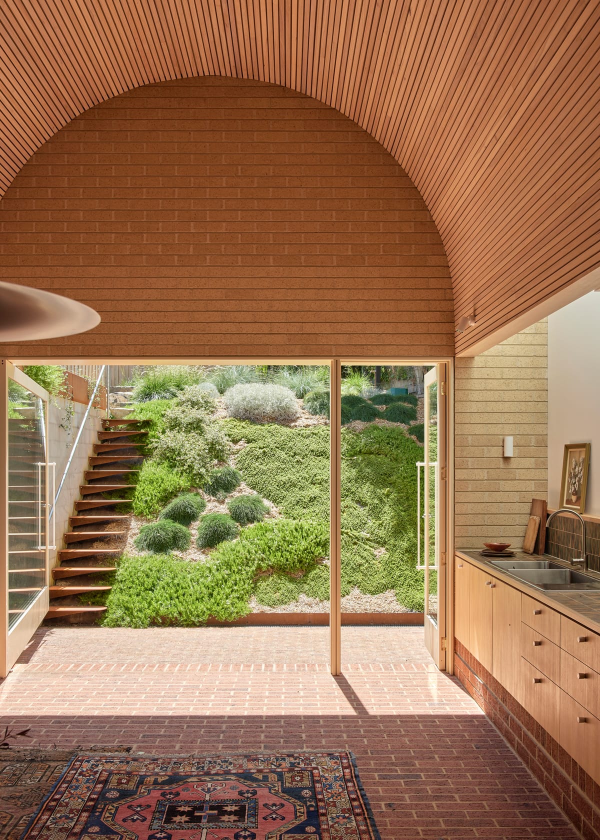 Harriet's House by SO:Architecture. Photography by Sean Fennessy. Kitchen overlooking garden. Brick floors. 