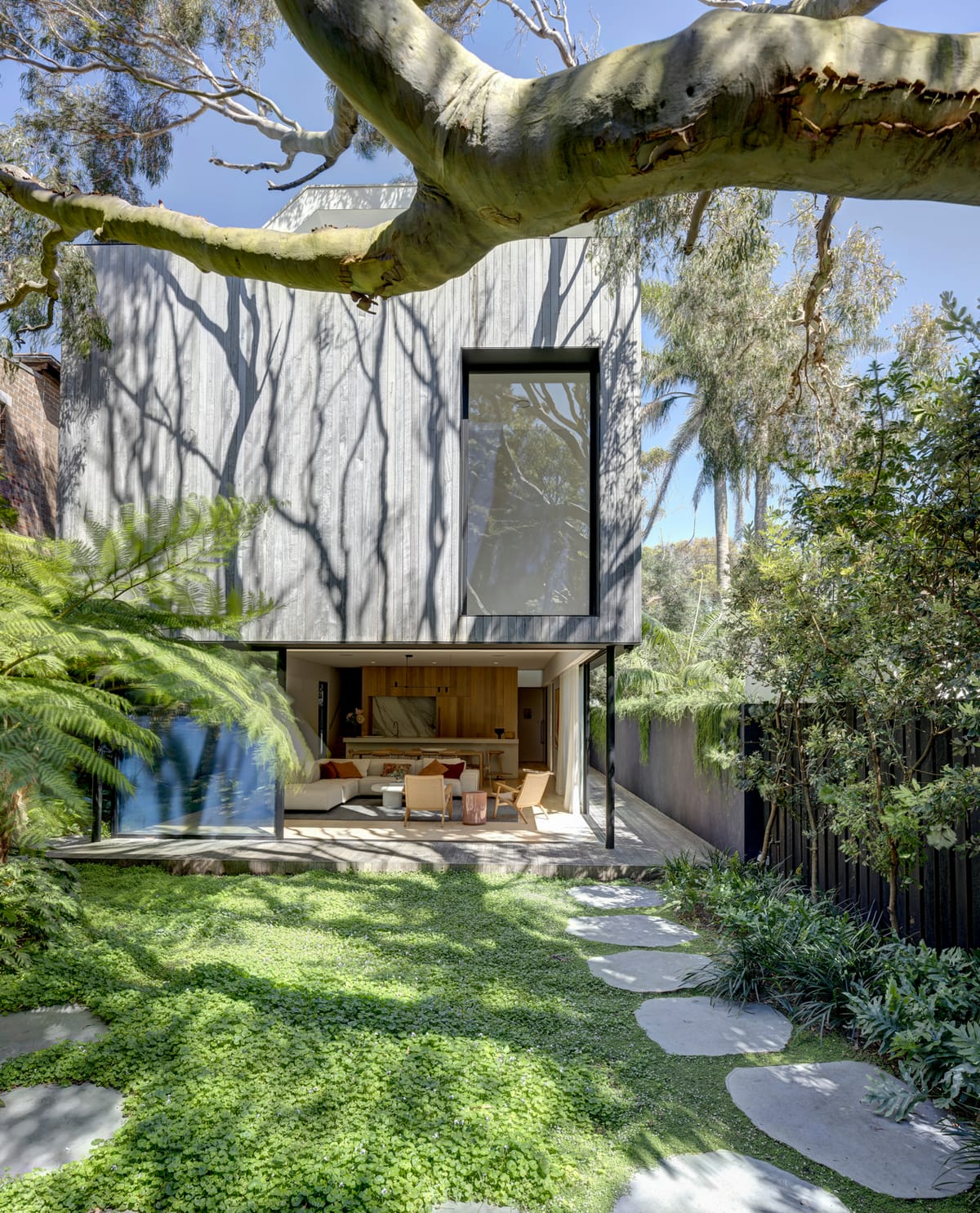 Quarry Box by MCK Architects. Photography by Brett Boardman. Exterior facade of double story home with lush backyard.